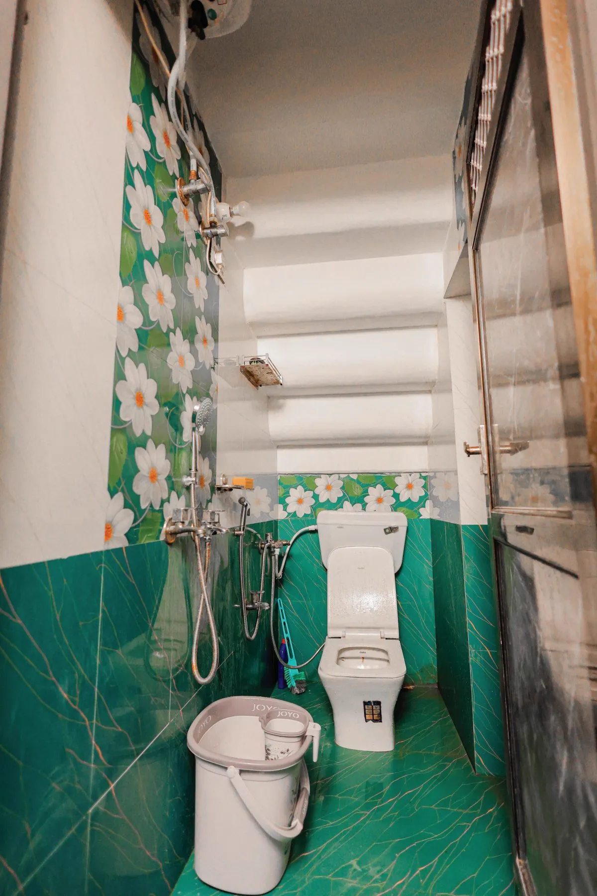 Sparkling clean attached bathroom with Western toilet, hot water geyser and shower at The Jawai Niwas