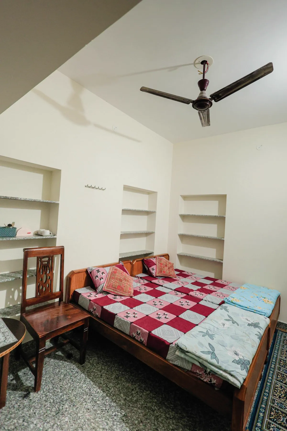 Cozy single beds with traditional Rajasthani quilts in non-AC room at The Jawai Niwas