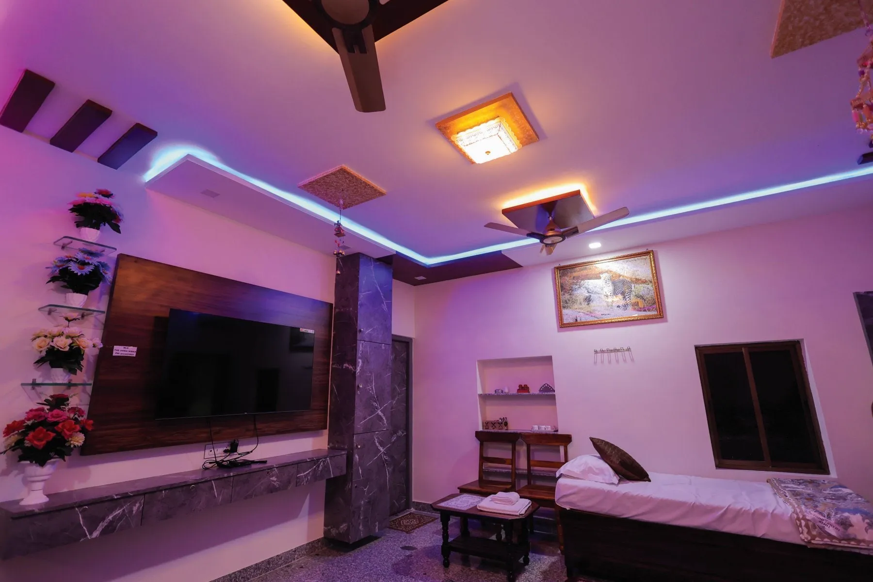 Non-AC single room with wall mounted television and ventilation at The Jawai Niwas