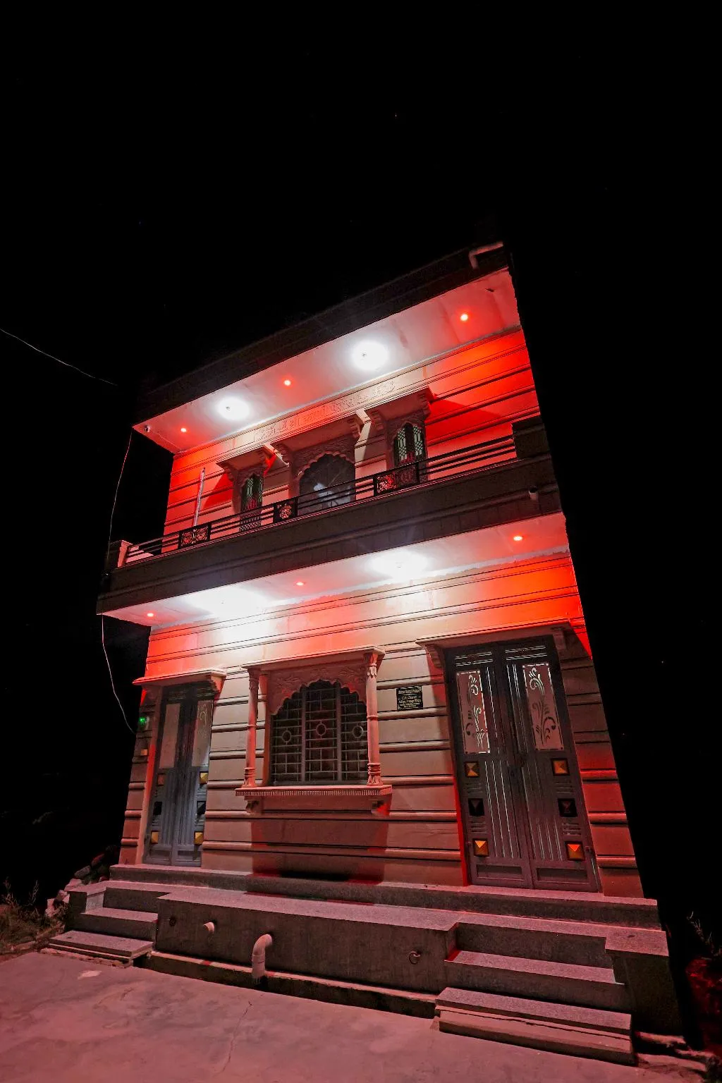 Architectural facade of The Jawai Niwas homestay at night near Jawai Bandh